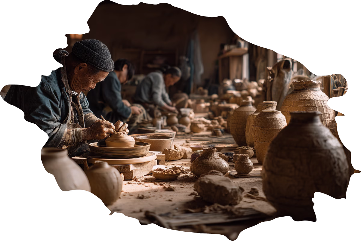 Pottery workshop with hands shaping clay.